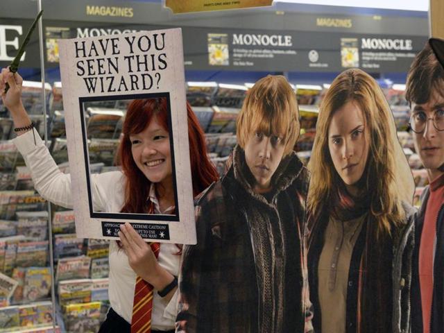 A fan poses for photograph next to a poster at the launch of the book in Singapore. (AFP) A fan poses for photograph next to a poster at the launch of the book in Singapore. (AFP)
