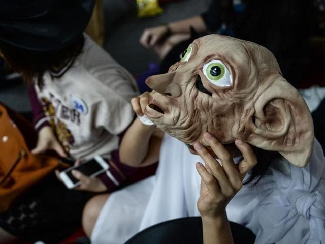 A Harry Potter fan dressed as Dobby waits to receive his copy of the book in Bangkok on Sunday. (AFP) A Harry Potter fan dressed as Dobby waits to receive his copy of the book in Bangkok on Sunday. (AFP)