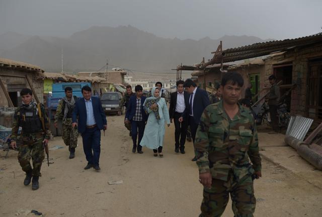 Muradi walking through a bazaar in Nili with delegates and security personnel. (AFP) Muradi walking through a bazaar in Nili with delegates and security personnel. (AFP)