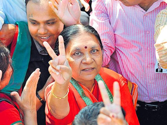 Gujarat chief minister Anandiben Patel flashes the victory sign during a BJP rally.(AFP File Photo)