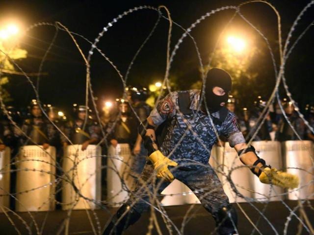Riot police block the street towards the Presidential Residence to prevent a march of anti-government protesters. (AP) Riot police block the street towards the Presidential Residence to prevent a march of anti-government protesters. (AP)