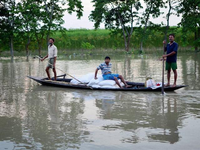 Villagers carrying flood relief items on a country boat in flood-affected Pasahbari ,30 km from Guwahati, in Assam. (PTI) Villagers carrying flood relief items on a country boat in flood-affected Pasahbari ,30 km from Guwahati, in Assam. (PTI)