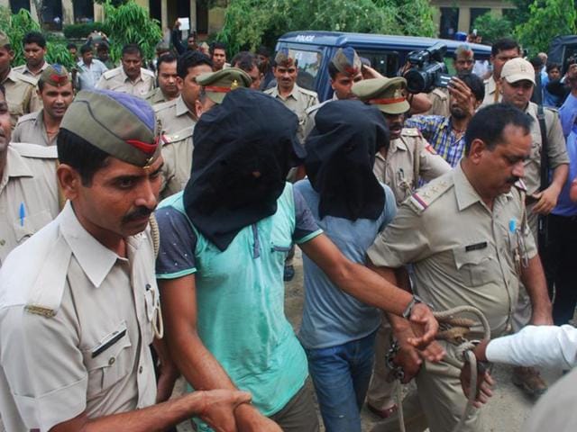 Police escort two of the Bulandshahr gangrape accused to a fast track court on Monday.(Sakib Ali/HT Photo)
