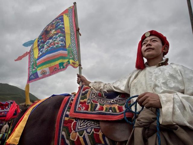 A Tibetan wearing a traditional costume awaits his turn. (AFP) A Tibetan wearing a traditional costume awaits his turn. (AFP)