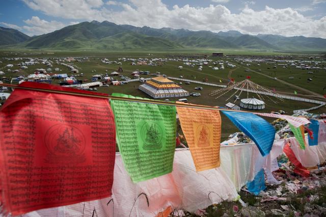 Buddhist prayer flags flutter in the wind on top of a hill at the festival. (AFP) Buddhist prayer flags flutter in the wind on top of a hill at the festival. (AFP)