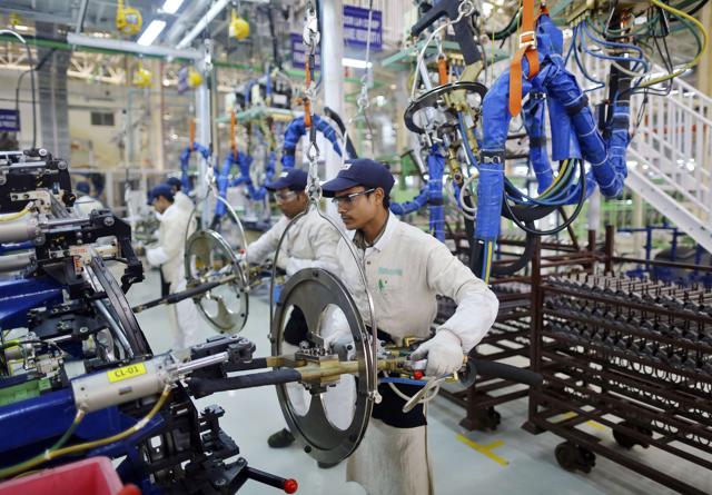 Employees work at the assembly line of a car manufacturing plant in Rajasthan. (REUTERS) Employees work at the assembly line of a car manufacturing plant in Rajasthan. (REUTERS)