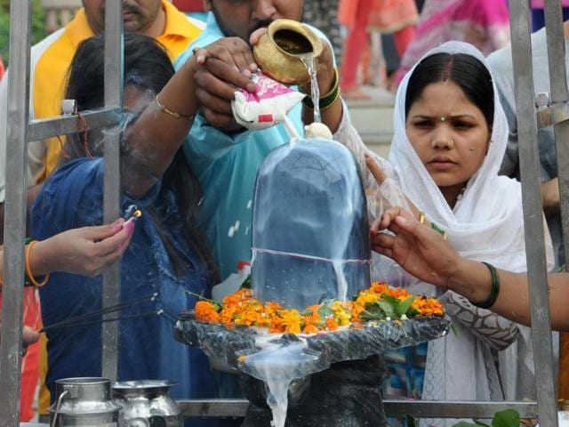 Devotees offer prayer on Savan Shivratri festival at a temple in Gurgaon. (Parveen Kumar/HT Photo) Devotees offer prayer on Savan Shivratri festival at a temple in Gurgaon. (Parveen Kumar/HT Photo)