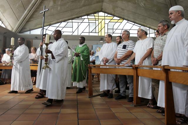 Muslim worshippers stand up as clerics arrive in the Saint-Pierre-de-l’Ariane church in Nice. Muslims across France were invited to participate in Catholic Sunday service to mourn the murder of a priest by jihadist teenagers, sparking fears of religious tension. (AFP) Muslim worshippers stand up as clerics arrive in the Saint-Pierre-de-l’Ariane church in Nice. Muslims across France were invited to participate in Catholic Sunday service to mourn the murder of a priest by jihadist teenagers, sparking fears of religious tension. (AFP)