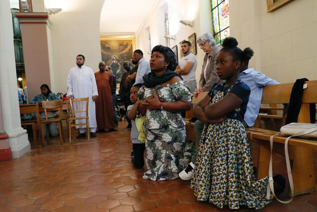 People pray during a mass in tribute at the Saint-Leu – Saint-Gilles Bagnolet's Church. (AFP) People pray during a mass in tribute at the Saint-Leu – Saint-Gilles Bagnolet's Church. (AFP)