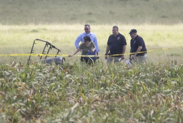 The partial frame of a hot air balloon is visible above a crop field as investigators comb the wreckage of a crash Saturday morning near Lockhart, Texas. Authorities say the accident caused a "significant loss of life”. (AP) The partial frame of a hot air balloon is visible above a crop field as investigators comb the wreckage of a crash Saturday morning near Lockhart, Texas. Authorities say the accident caused a "significant loss of life”. (AP)