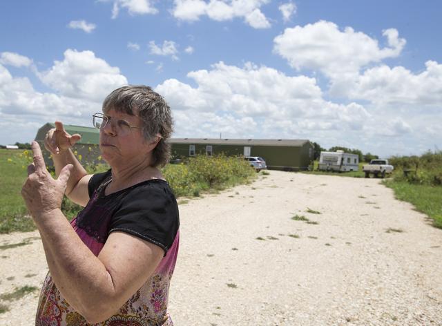 Local resident Margaret Wylie describes a burst of flames she saw in the field across the road from her house at the scene of a hot air balloon crash near Lockhart. (AP) Local resident Margaret Wylie describes a burst of flames she saw in the field across the road from her house at the scene of a hot air balloon crash near Lockhart. (AP)
