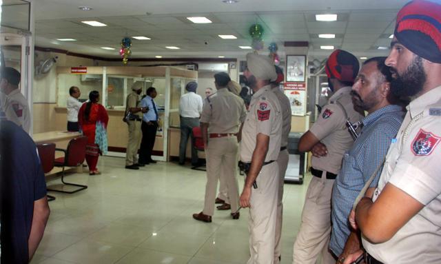Police at the robbed bank in Ludhiana on Monday. (JS Grewal/HT Photo) Police at the robbed bank in Ludhiana on Monday. (JS Grewal/HT Photo)