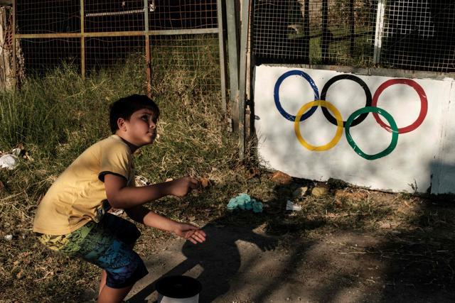 Nine-year-old Leoin front of a garage decorated with the Olympic rings ahead of Rio 2016 Olympic Games. (AFP Photo) Nine-year-old Leoin front of a garage decorated with the Olympic rings ahead of Rio 2016 Olympic Games. (AFP Photo)
