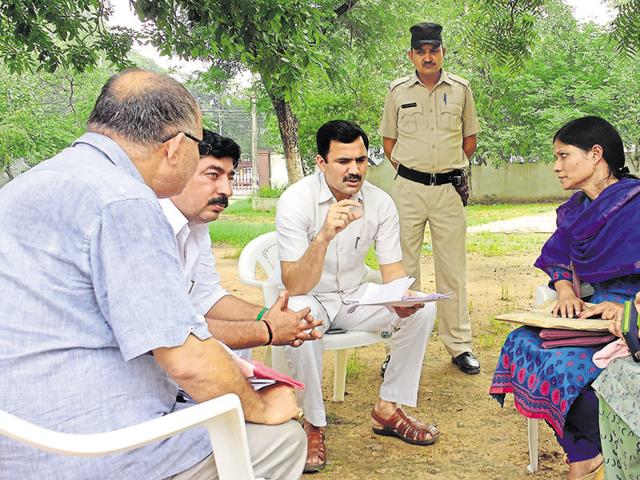 Huda administrator Yashpal Yadav (centre) with Dwarka Expressway evictees during the draw of lots at John Hall in Civil Lines on Sunday. Huda administrator Yashpal Yadav (centre) with Dwarka Expressway evictees during the draw of lots at John Hall in Civil Lines on Sunday.