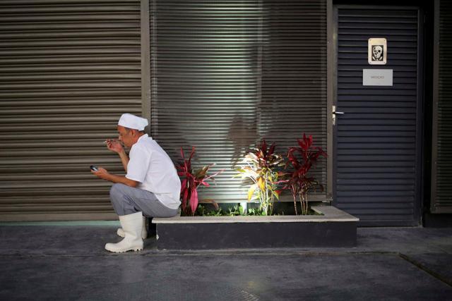 A man smokes a cigarette at a hotel outside the Olympic Park. (Reuters Photo) A man smokes a cigarette at a hotel outside the Olympic Park. (Reuters Photo)