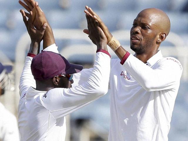 West Indies' spin bowler Roston Chase, right, celebrates with teammate Jermaine Blackwood. (AP Photo) West Indies' spin bowler Roston Chase, right, celebrates with teammate Jermaine Blackwood. (AP Photo)