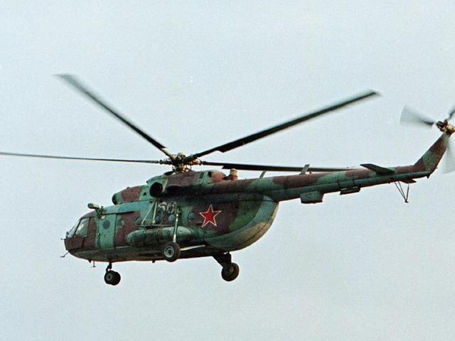 In this in this 2002 file photo, a Mi-8 helicopter flies over the Chechen regional capital Grozny, Russia. A helicopter similar to the one pictured has been shot down in Syria and Russian President Vladimir Putin's spokesman says all people aboard it have been killed.(AP file)