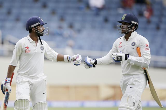Rahane, left, and Umesh Yadav leave the field after India declared their innings 500/9 (AP)