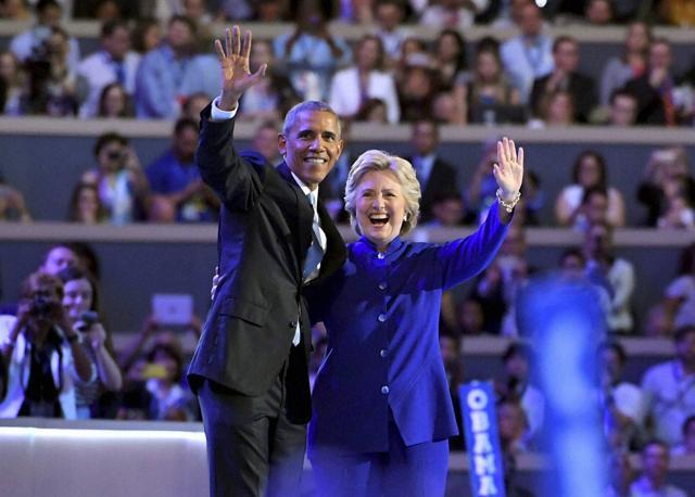 President Barack Obama and Democratic Presidential candidate Hillary Clinton wave together during the third day of the Democratic National Convention in Philadelphia on July 27, 2016. (AP) President Barack Obama and Democratic Presidential candidate Hillary Clinton wave together during the third day of the Democratic National Convention in Philadelphia on July 27, 2016. (AP)