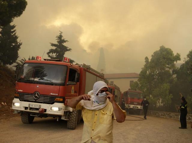 Local residents and firefighters try to save Galataki Monastery as a fire approaches the area near the seaside village of Limni on the island of Evia, about 160kilometers (100 miles) north of Athens. (AP Photo) Local residents and firefighters try to save Galataki Monastery as a fire approaches the area near the seaside village of Limni on the island of Evia, about 160kilometers (100 miles) north of Athens. (AP Photo)