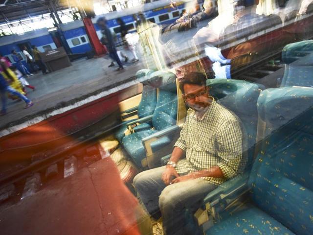 A Rail fan club member sits inside the coach, which have seats upholstered in blue.  The train traveled the distance in 12.5 hours at 130 km per hour speed during a trial run. (ARIJIT SEN/Hindustan Times) 