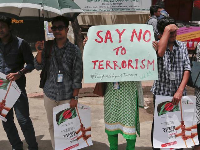 Bangladeshi students and teachers hold placards as they form a human chain to protest terrorism in Dhaka on Monday. (AFP) Bangladeshi students and teachers hold placards as they form a human chain to protest terrorism in Dhaka on Monday. (AFP)