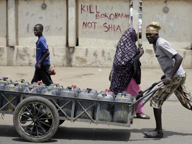 In this file photo, people walk past a sign reading "Kill Boko Haram not shia" in Kano, Nigeria. (AP) In this file photo, people walk past a sign reading "Kill Boko Haram not shia" in Kano, Nigeria. (AP)
