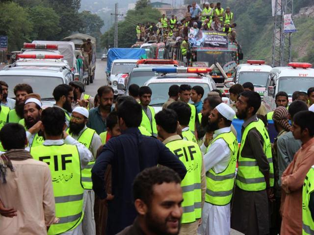 Activists of the Falah-e-Insaniat Foundation gather before travelling to Kashmir with relief material, in Muzaffarabad, Pakistan. (AP) Activists of the Falah-e-Insaniat Foundation gather before travelling to Kashmir with relief material, in Muzaffarabad, Pakistan. (AP)