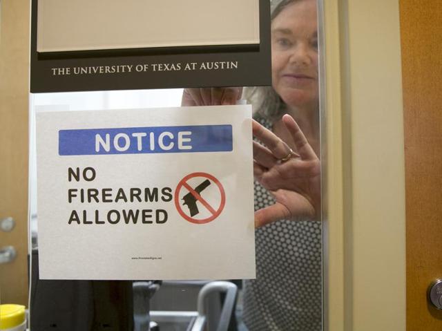 University of Texas at Austin Anthropology professor Pauline Strong posts a sign prohibiting guns at her office on the first day of the new campus-carry law on Monday. The law pushed by Gov. Greg Abbott and the Republican legislative majority will make Texas one of a handful of states that guarantee the right to carry concealed handguns on campus. (Jay Jenner/Austin American-Statesmanvia AP) (AP) University of Texas at Austin Anthropology professor Pauline Strong posts a sign prohibiting guns at her office on the first day of the new campus-carry law on Monday. The law pushed by Gov. Greg Abbott and the Republican legislative majority will make Texas one of a handful of states that guarantee the right to carry concealed handguns on campus. (Jay Jenner/Austin American-Statesmanvia AP) (AP)