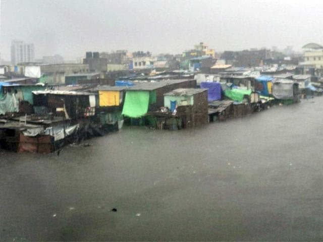 Indian Coast Guard helicopter rescued 28 people, trapped on rooftops due to the flash floods along Auranga river, Valsad. (@ManishPaathak/Twitter) Indian Coast Guard helicopter rescued 28 people, trapped on rooftops due to the flash floods along Auranga river, Valsad. (@ManishPaathak/Twitter)