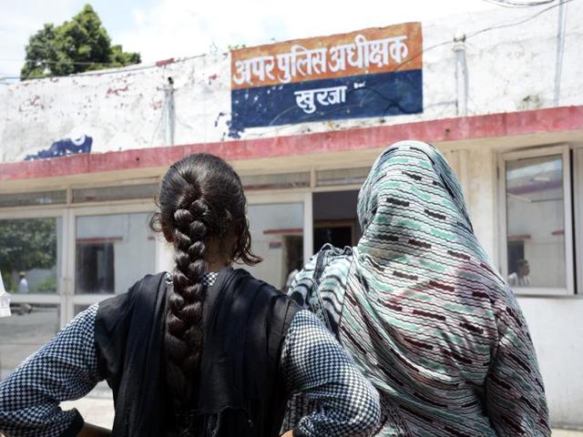 Women wait outside the office of the senior superintendent of police in Bulandshahr, where a woman and her teenaged daughter were robbed and raped on a highway, to report a crime. (Sakib Ali /HT photo) Women wait outside the office of the senior superintendent of police in Bulandshahr, where a woman and her teenaged daughter were robbed and raped on a highway, to report a crime. (Sakib Ali /HT photo)