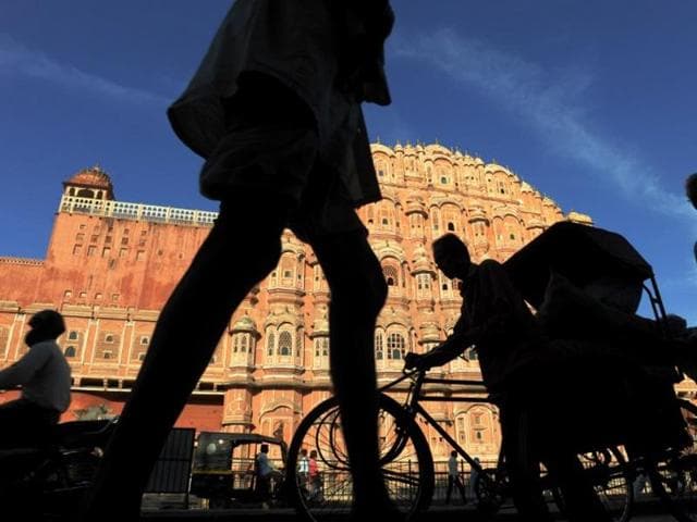 Residents walk past the Hawa Mahal, the "Palace of Winds", in the old walled city of Jaipur.(AFP File Photo)