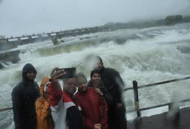 Youngster take selfie in front of Khadakwasla dam at Kadakwasla dam in Pune, India, on Wednesday.