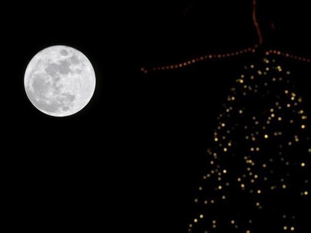 A full moon rises in the sky over a Christmas tree in Beirut, Lebanon. (File Photo) A full moon rises in the sky over a Christmas tree in Beirut, Lebanon. (File Photo)