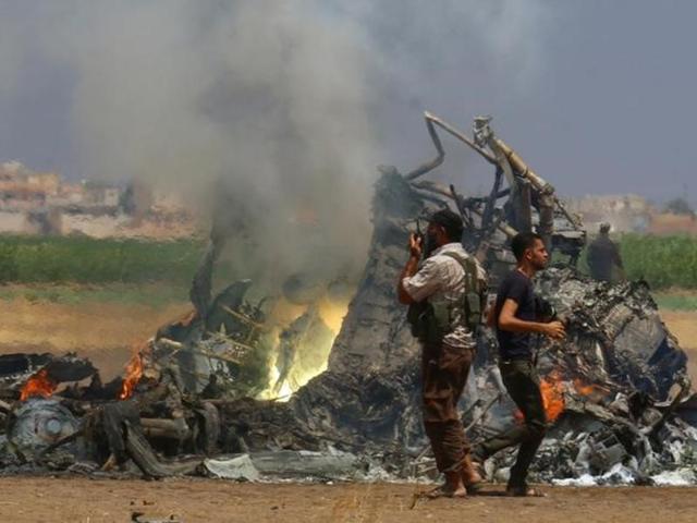 Men inspect the wreckage of a Russian helicopter that had been shot down in the north of Syria's rebel-held Idlib province. (Reuters) Men inspect the wreckage of a Russian helicopter that had been shot down in the north of Syria's rebel-held Idlib province. (Reuters)