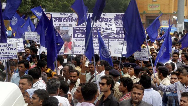 Members of Dalit community protest in Ahmedabad on Tuesday against the assault on Dalit members by “cow protectors” in Rajkot district, Gujarat. (PTI) Members of Dalit community protest in Ahmedabad on Tuesday against the assault on Dalit members by “cow protectors” in Rajkot district, Gujarat. (PTI)