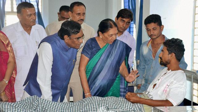 Gujarat chief minister Anandiben Patel visits a Dalit youth who was assaulted by ‘cow vigilantes’ in Rajkot. (PTI) Gujarat chief minister Anandiben Patel visits a Dalit youth who was assaulted by ‘cow vigilantes’ in Rajkot. (PTI)