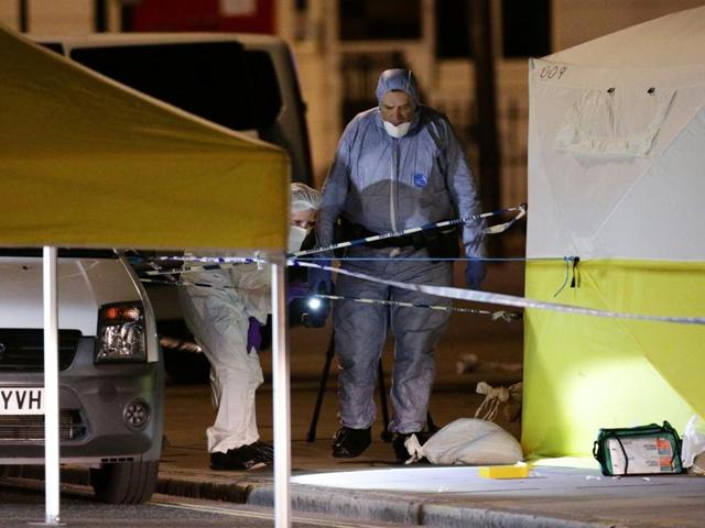 Police forensic officers work at Russell Square, central London, after a knife attack. (AP Photo)