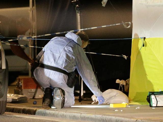A police forensic officer works at the scene in Russell Square. (AP Photo)