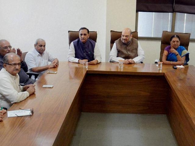 In this file photo, BJP president Amit Shah, former CM Anandiben Patel and BJP chief Vijay Rupani attend a party meeting in Gandhinagar.(PTI Photo)