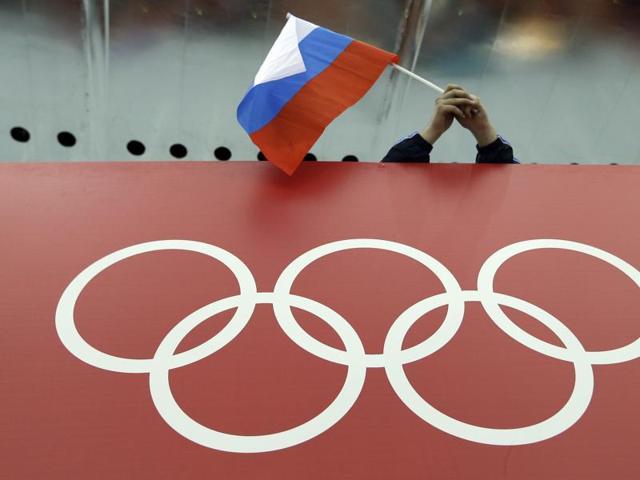 A file photo of Russian skating fan holds the country's national flag over the Olympic rings. (AP Photo) A file photo of Russian skating fan holds the country's national flag over the Olympic rings. (AP Photo)