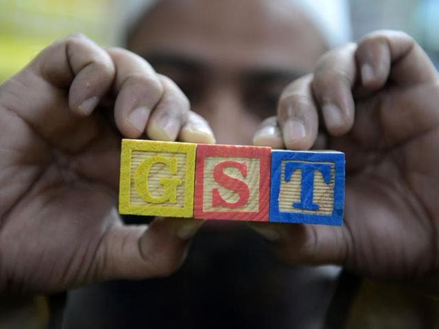 A trader shows letters GST representing "Goods and Services Tax" (GST) at his shop in Hyderabad. (AFP) A trader shows letters GST representing "Goods and Services Tax" (GST) at his shop in Hyderabad. (AFP)