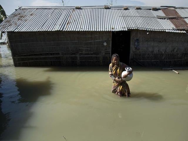 In this July 31, 2016, file photo, a flood affected family moves on a banana raft past a fishing net in Morigaon district, east of Guwahati, Assam.(AP) In this July 31, 2016, file photo, a flood affected family moves on a banana raft past a fishing net in Morigaon district, east of Guwahati, Assam.(AP)
