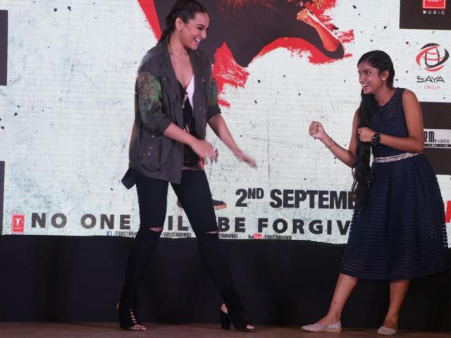 Sonakshi Sinha shares the stage with a fan during the song launch of Akira. (IANS)