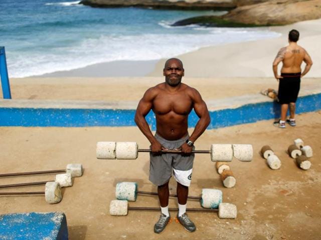 Marcos Da Costa, 46-year-old, poses as he works out at the Arpoador beach in Rio de Janeiro. When he asked if he had bought tickets for the Olympics he said, "I don't agree with the Olympics while people in Rio suffer violence, bad health services and insecurity. (REUTERS)