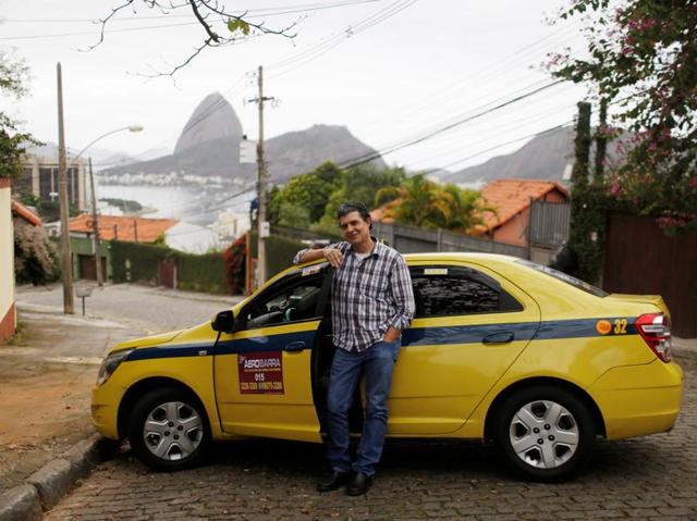 Abner Lelis, a taxi-driver, poses for a portrait in Rio de Janeiro. (REUTERS)