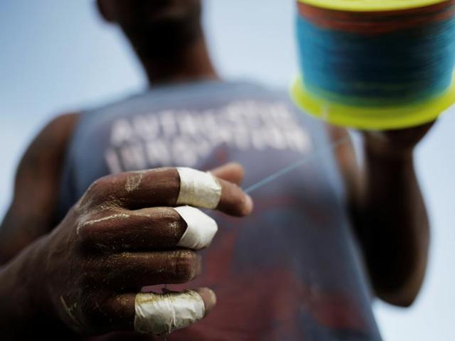 Kite-fliers take precautionary measures to avoid cuts caused by the sharp manja. (Reuters) Kite-fliers take precautionary measures to avoid cuts caused by the sharp manja. (Reuters)