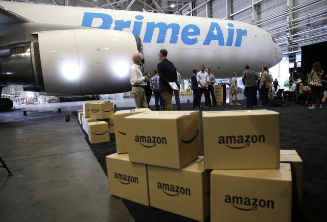 Amazon.com boxes are shown stacked near a Boeing 767 Amazon "Prime Air" cargo plane (AP)