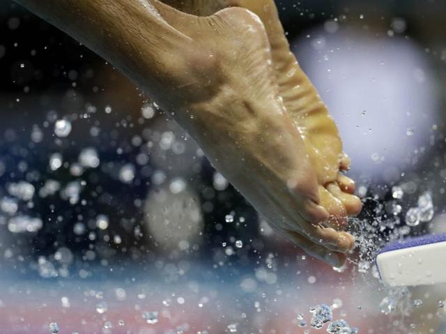 A swimmer enters the pool during a training session on Thursday. (AP Photo) (AP)