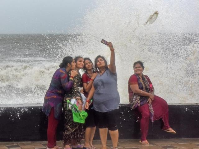 Mumbai, India - Aug. 5, 2016:People enjoy during a high tide at Worli seaface in Mumbai on Friday. (Pratik Chorge) 